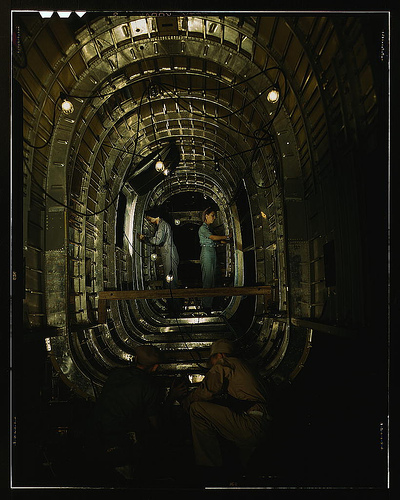 Installing structural parts of a C-87 transport plane in the tunnel of a tail fuselage section at the Consolidated Aircraft Corporation plant, Fort Worth, Texas  (LOC)