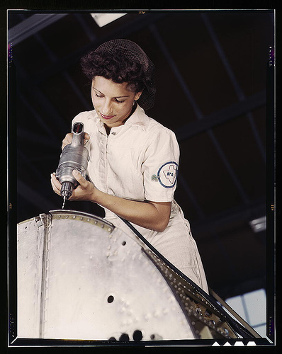 Oyida Peaks riveting as part of her NYA training to become a mechanic in the Assembly and Repair Department at the Naval Air Base, Corpus Christi, Texas  (LOC)